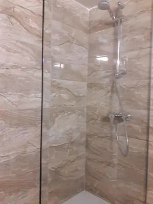 a bathroom with a shower with a glass door at P L Sunorama Beach Garden 302 in Larnaka