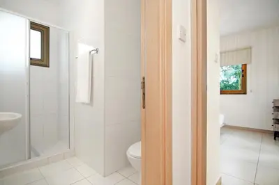a bathroom with a toilet and a sink at Villa Regina in Ayia Napa