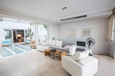 a living room with a couch and a tv at Leana Front Line Villa in Protaras
