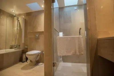 a bathroom with a toilet and a shower and a sink at Leana Front Line Villa in Protaras