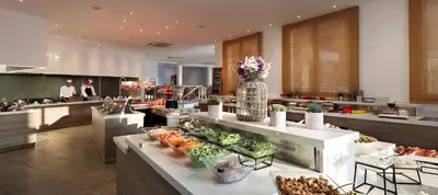 a restaurant with a buffet line with fruits and vegetables at Louis St. Elias Resort & Waterpark in Protaras