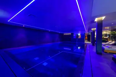 a large swimming pool in a house with blue lights at Ajax Hotel in Limassol