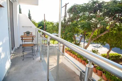 a balcony of a house with a table and chairs at Tikay Holiday Apts in Ayia Napa