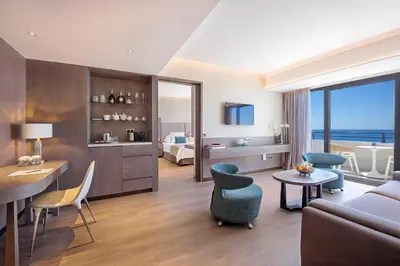 a living room with a couch and a room with a view at Amathus Beach Hotel Limassol in Limassol