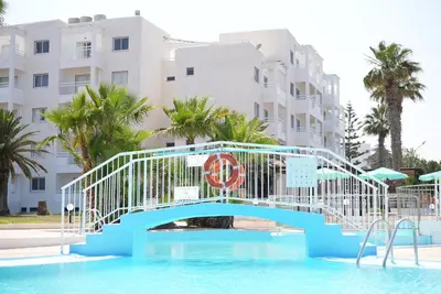 a bridge over a swimming pool in a resort at Astreas Beach Hotel Apartments in Protaras