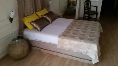 a bedroom with a bed with brown pillows at Sylva Hotel in Limassol