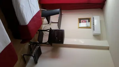 a room with a chair and a tv in a room at Sylva Hotel in Limassol
