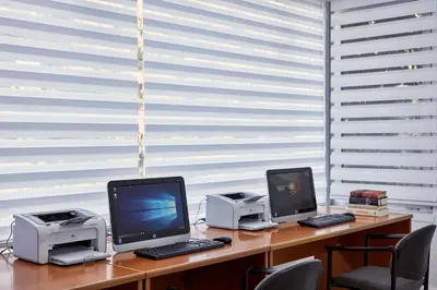 two computers sitting on a desk in front of a window at Grecian Bay in Ayia Napa