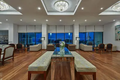 a large living room with a table and chairs at Grecian Bay in Ayia Napa