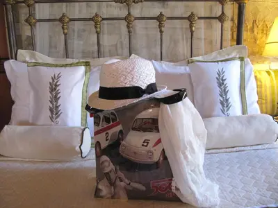 a picture of a wedding dress and a hat on a bed at Stratos ArtDeco House in Kalavasos
