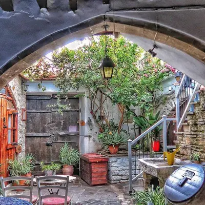 a patio with a bunch of plants and a building at Stratos ArtDeco House in Kalavasos
