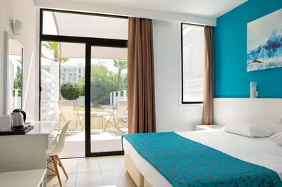 a hotel room with a bed and a balcony at Lantiana Napa Aparthotel in Ayia Napa
