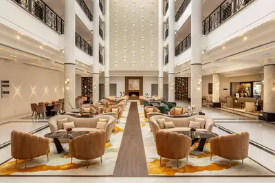 a lobby with couches and tables in a building at Hilton Nicosia in Nicosia