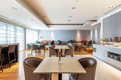 a dining room with tables and chairs and a restaurant at Hilton Nicosia in Nicosia