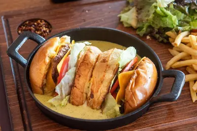 a bowl of food with sandwiches and french fries at Rise Urban Art Hotel in Larnaka