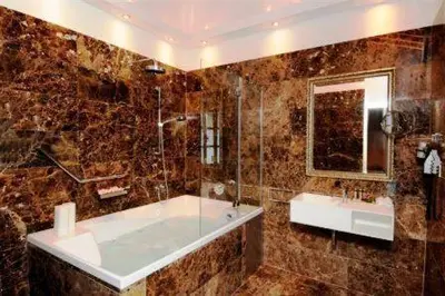 a bathroom with a tub and a sink and a mirror at The Library Hotel Wellness Retreat in Kalavasos