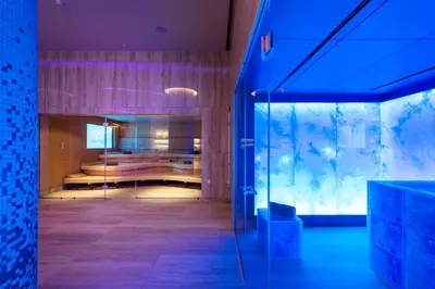 a room with a bed and a glass wall at Adams Beach Hotel & Spa in Ayia Napa