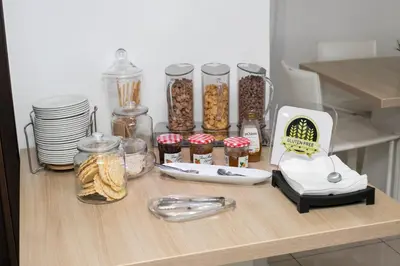 a table with jars of food and other items on it at Les Palmiers Beach Boutique Hotel & Luxury Apartments in Larnaka