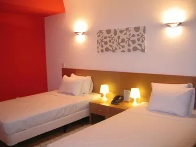 a hotel room with two beds and a telephone at Allegra GSP Sport Center in Nicosia
