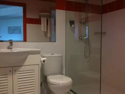 a bathroom with a toilet and a sink and a shower at Allegra GSP Sport Center in Nicosia