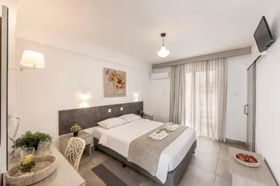 a bedroom with a bed and a table and a television at Cactus in Larnaka