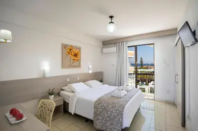 a hotel room with a bed and a balcony at Cactus in Larnaka