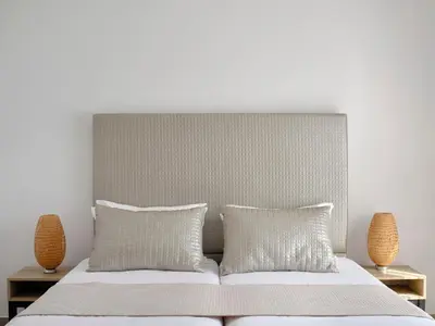 a bedroom with a white bed with two pillows at Atlantica Panthea Resort in Ayia Napa
