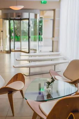 a lobby with chairs and a glass table at Napa Plaza Hotel (Adults Only) in Ayia Napa
