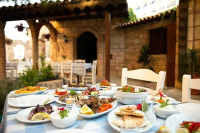 a table with plates of food on it at Golden Bay Beach Hotel in Larnaka