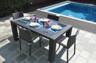 a table and chairs next to a swimming pool at Katikies 22 in Pissouri