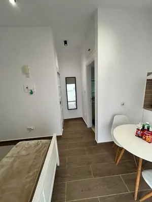 a living room with a table and a dining room at Harmony Studios in Larnaka
