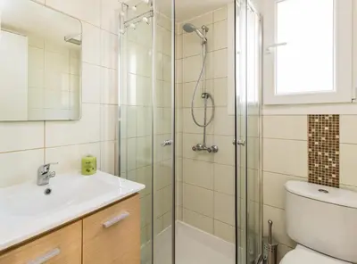 a bathroom with a shower and a toilet and a sink at Harmony Studios in Larnaka