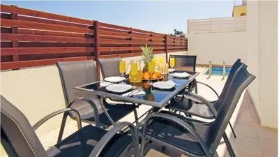 a table and chairs on a balcony with a table and chairs at Villa Florie in Protaras