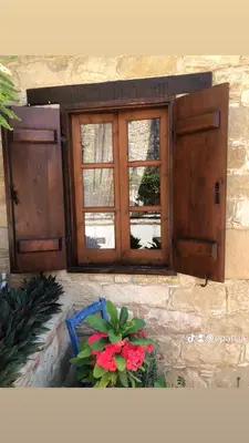 a window on a building with flowers in a basket at Niki's House in Limassol
