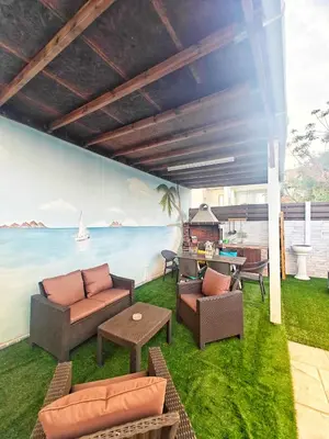 a patio with couches and a fireplace and the ocean at Mamas Summer House in Larnaka