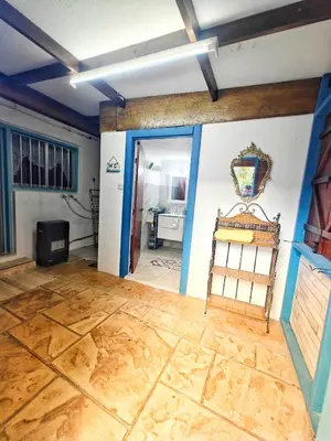 a living room with a wooden floor and a doorway at Mamas Summer House in Larnaka