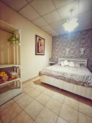 a bedroom with a bed and a stone wall at Mamas Summer House in Larnaka