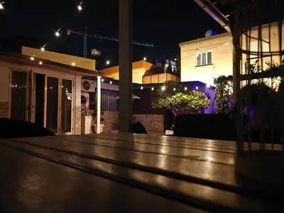 a wooden table in a patio at night at Mamas Summer House in Larnaka