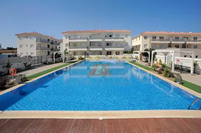 a large swimming pool in front of two apartment buildings at Sunny Cyprus in Paralimni