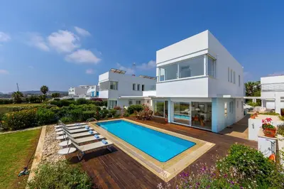 a villa with a swimming pool and a house at Protaras Beachfront Villa Alia in Protaras