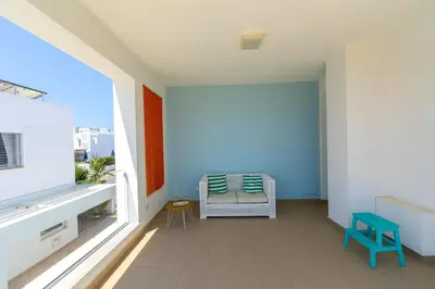 a balcony with a chair and a window at Protaras Beachfront Villa Alia in Protaras