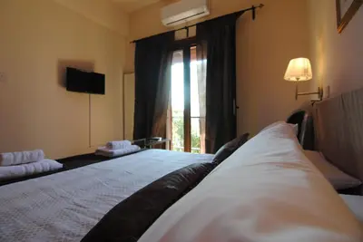 a bedroom with a large bed with a window at La C Mer in Larnaka