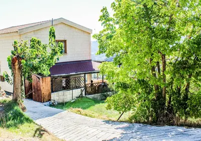 a house with a tree and a driveway at Vasiliou House in Khandria