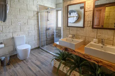 a bathroom with two sinks and a shower at Vasiliou House in Khandria