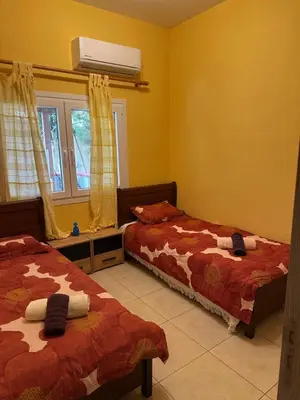 a bedroom with two beds and a air conditioner at Vergi Apartments in Pyla