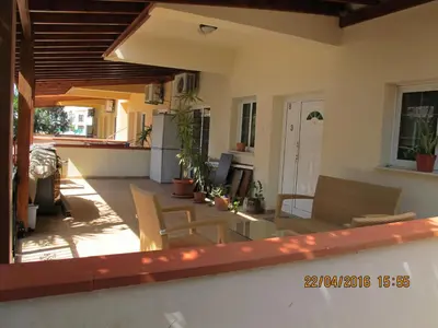 a patio with a table and chairs on a house at Vergi Apartments in Pyla
