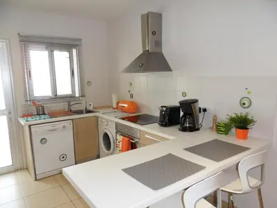 a kitchen with a sink and a washing machine at Eden Beach Apartment 207 in Limassol