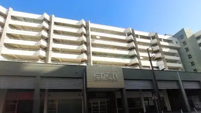an apartment building with a sign on the front of it at Eden Beach Apartment 207 in Limassol