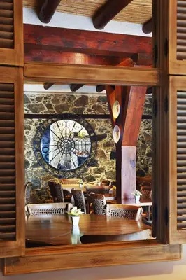 a dining room with a large clock on a wall at Aristotelio Boutique Hotel in Pedoulas