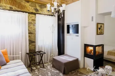 a bedroom with a bed and a fireplace in it at Aristotelio Boutique Hotel in Pedoulas
